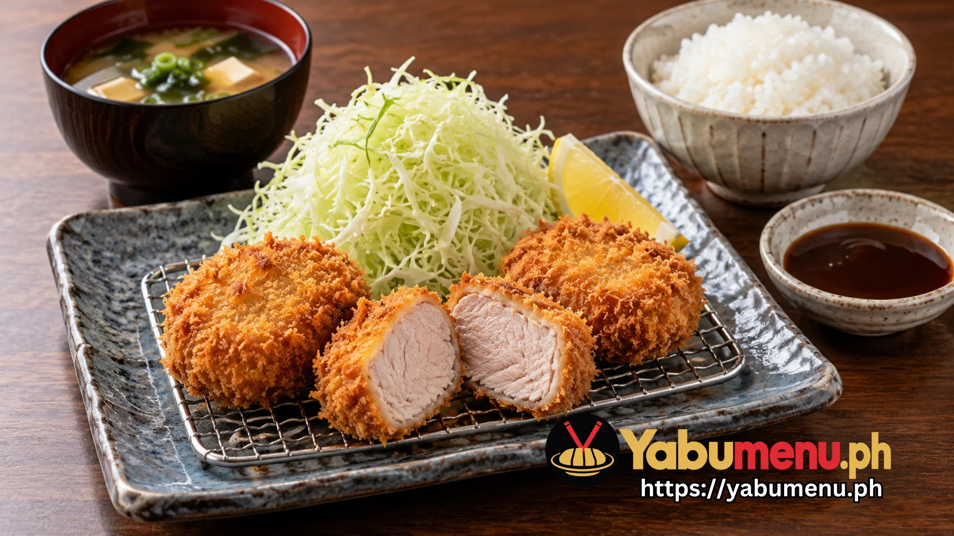 Japanese pork katsu served with rice, cabbage and dipping sauce